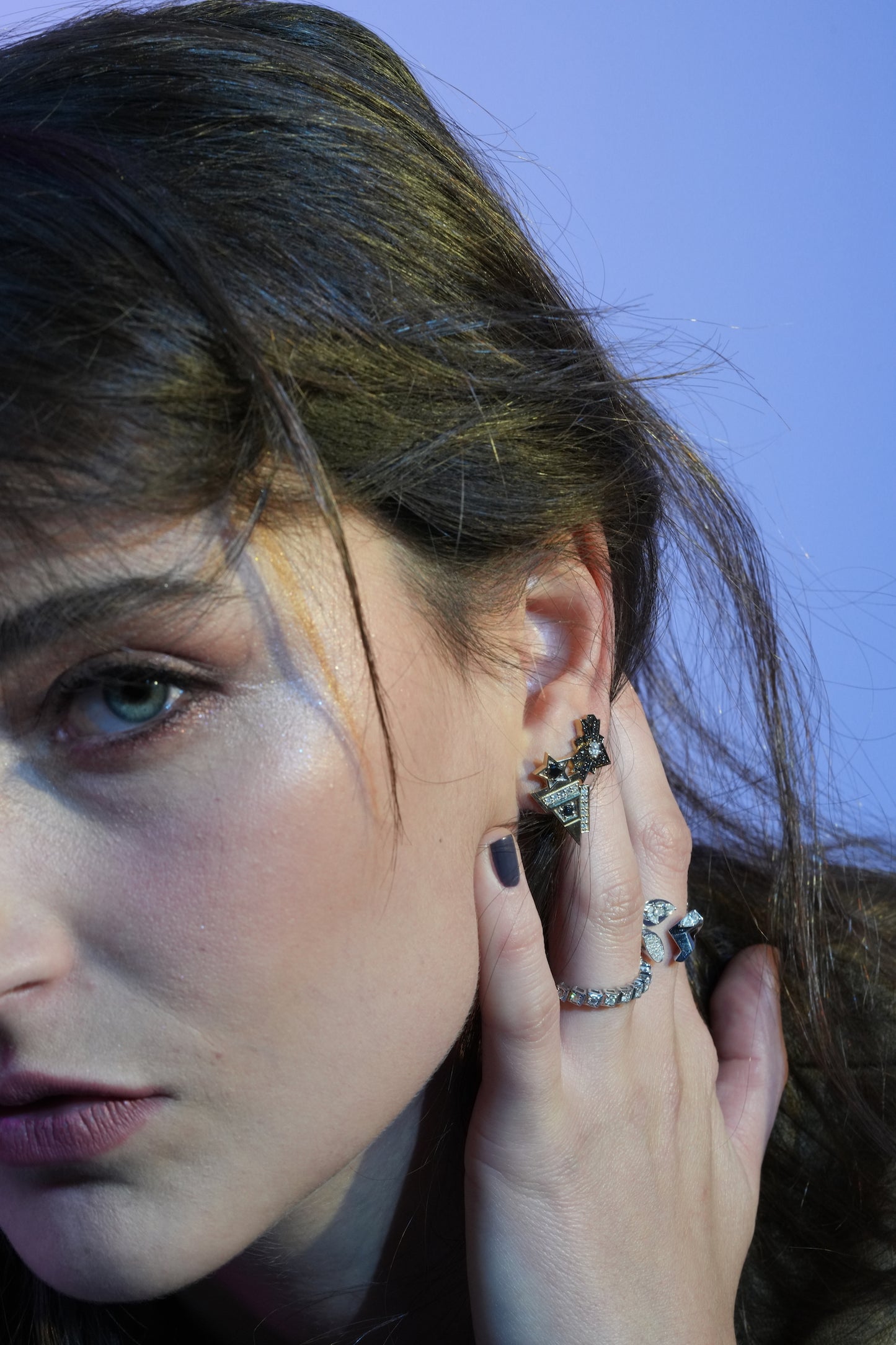 Woman wearing Meteors Grace earrings showcasing their style and design. Jewelry detail and face close-up.