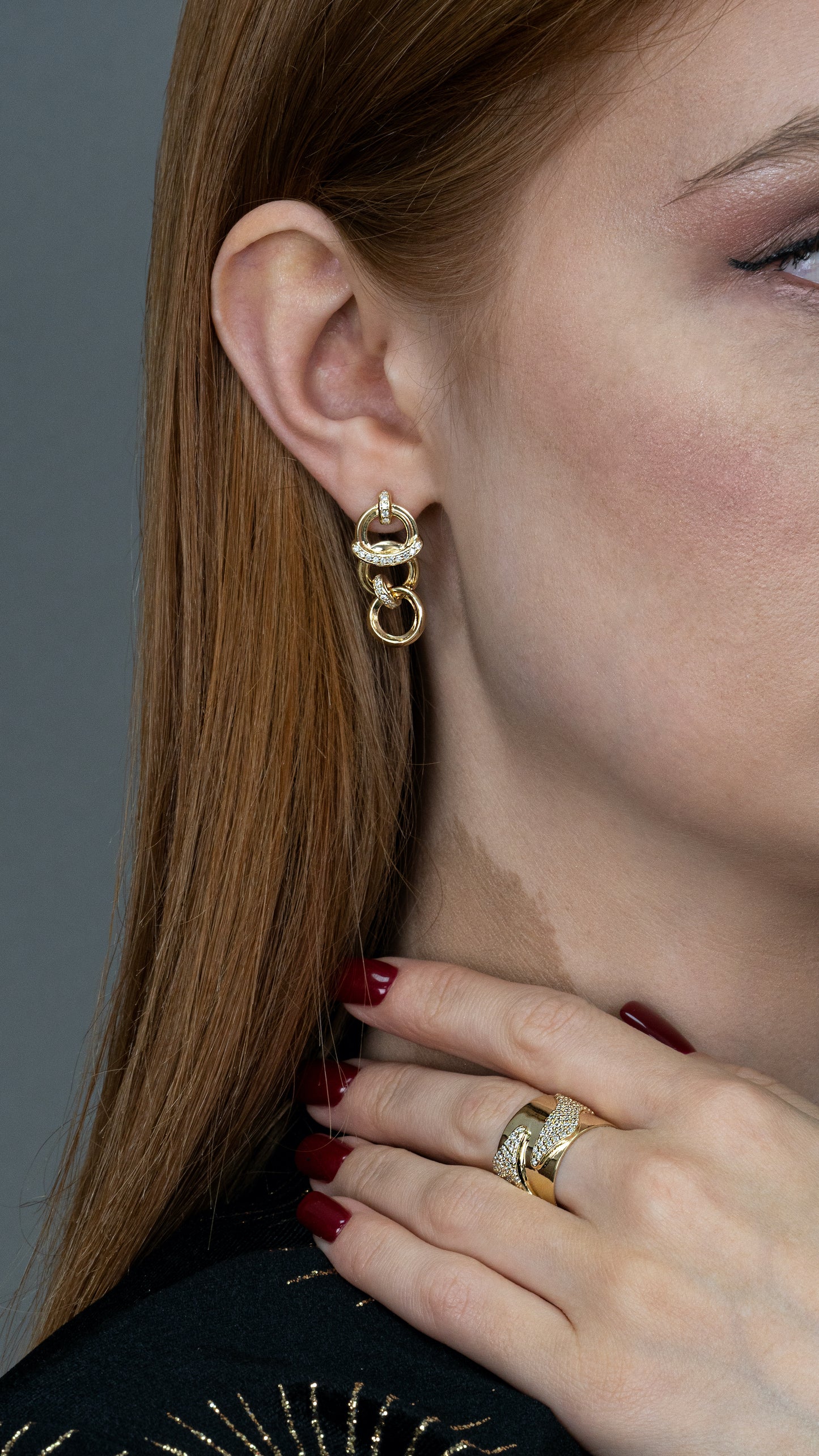 Model showcasing Luminara Connect earrings and ring, gold jewelry with diamond accents.