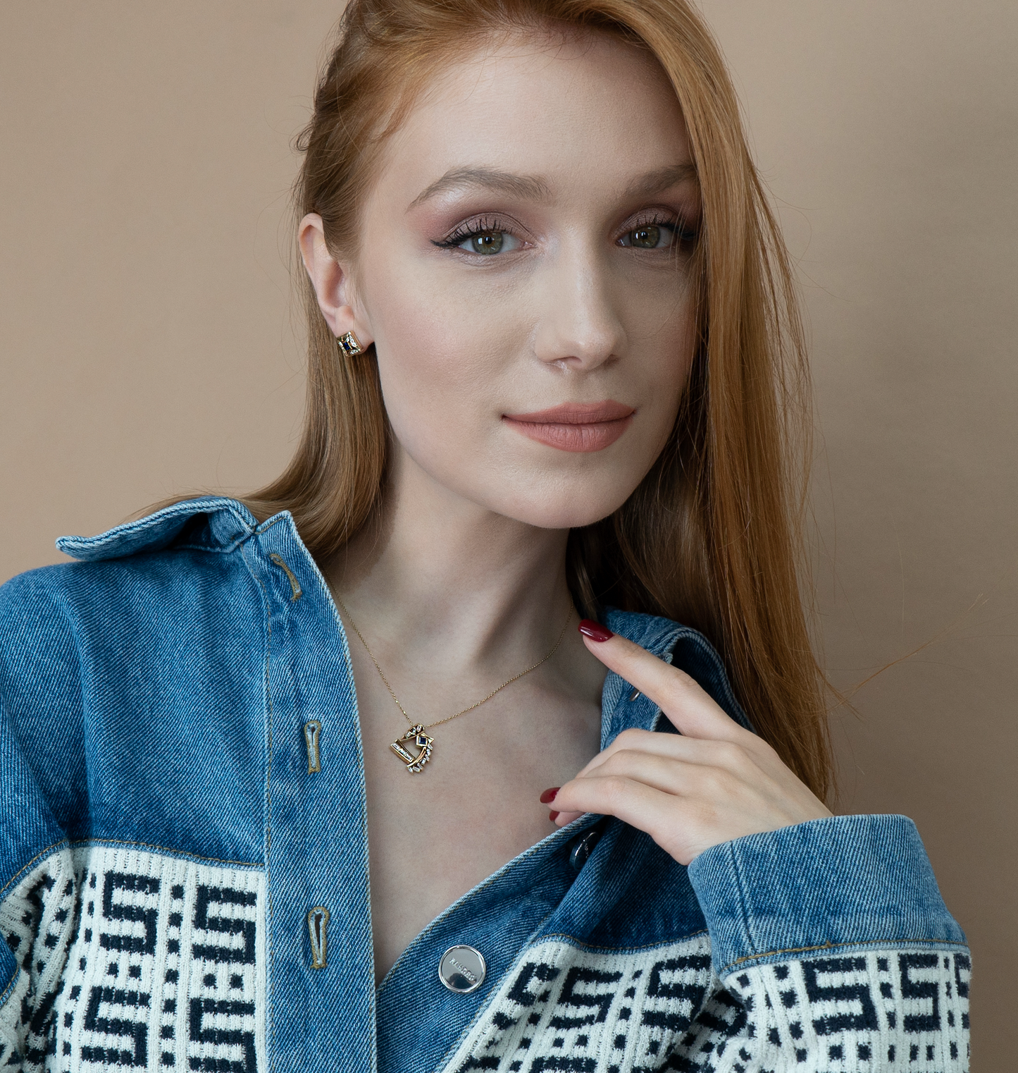 Model wearing Sapphire Universe Necklace; perfect jewelry gift. Denim jacket with geometric pattern.